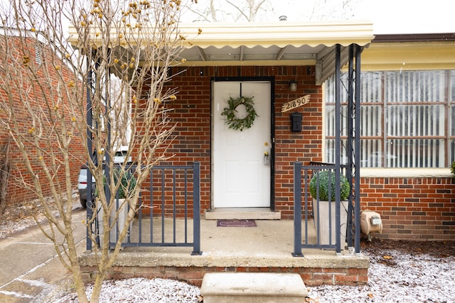 view of snow covered property entrance