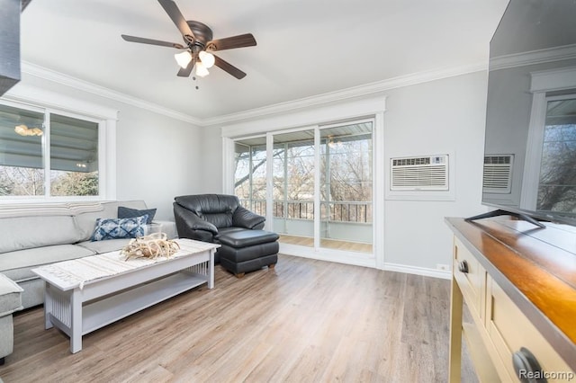 living area featuring light wood-style floors, crown molding, a ceiling fan, and a wealth of natural light