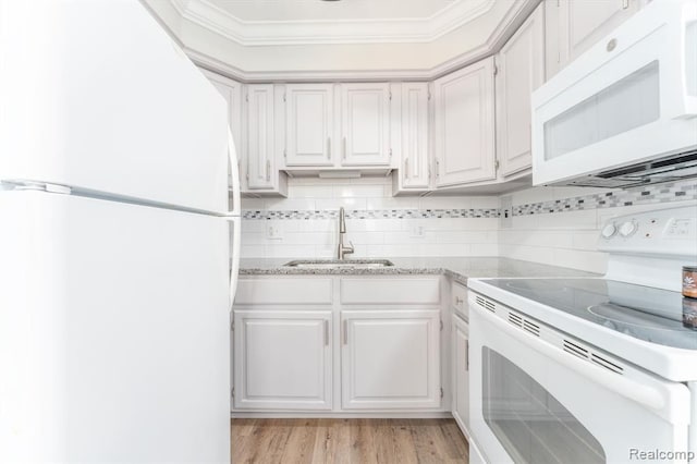 kitchen featuring white cabinets, a sink, white appliances, decorative backsplash, and ornamental molding