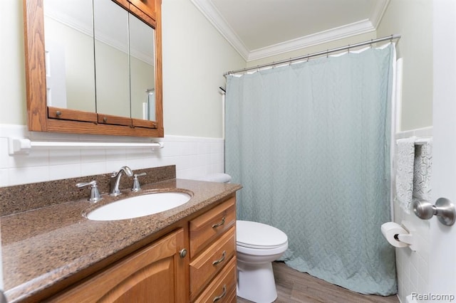 full bathroom featuring wood finished floors, vanity, a wainscoted wall, toilet, and ornamental molding