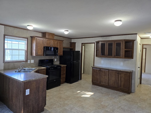 kitchen with kitchen peninsula, ornamental molding, dark brown cabinetry, sink, and black appliances