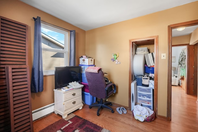 office featuring light hardwood / wood-style flooring and a baseboard heating unit