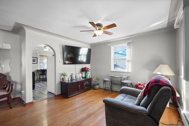 living room featuring ceiling fan and light hardwood / wood-style floors