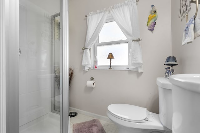 bathroom featuring toilet and an enclosed shower