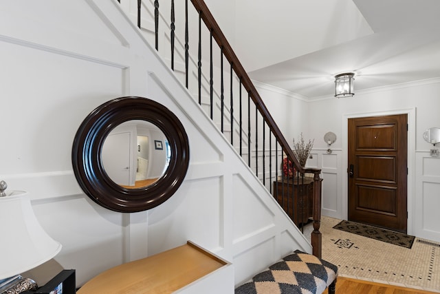 entrance foyer featuring ornamental molding