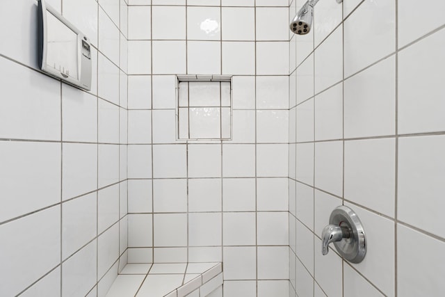 bathroom with tiled shower