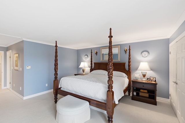 carpeted bedroom with a closet and crown molding