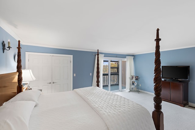 carpeted bedroom featuring access to exterior, a closet, and ornamental molding