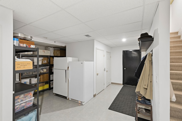 kitchen with white refrigerator and a drop ceiling