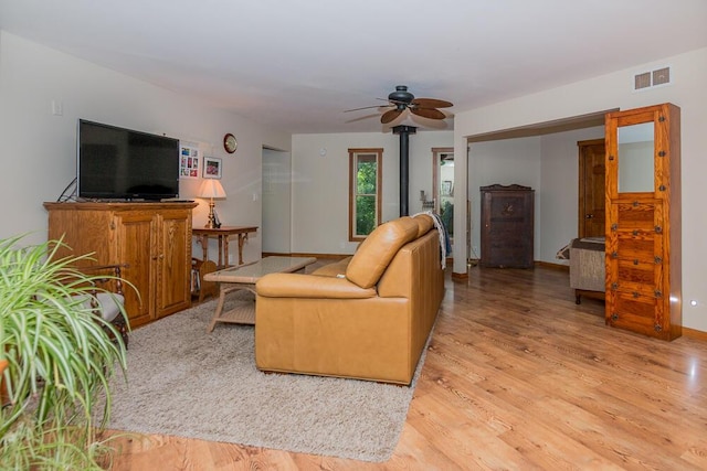 living room featuring light hardwood / wood-style floors and ceiling fan