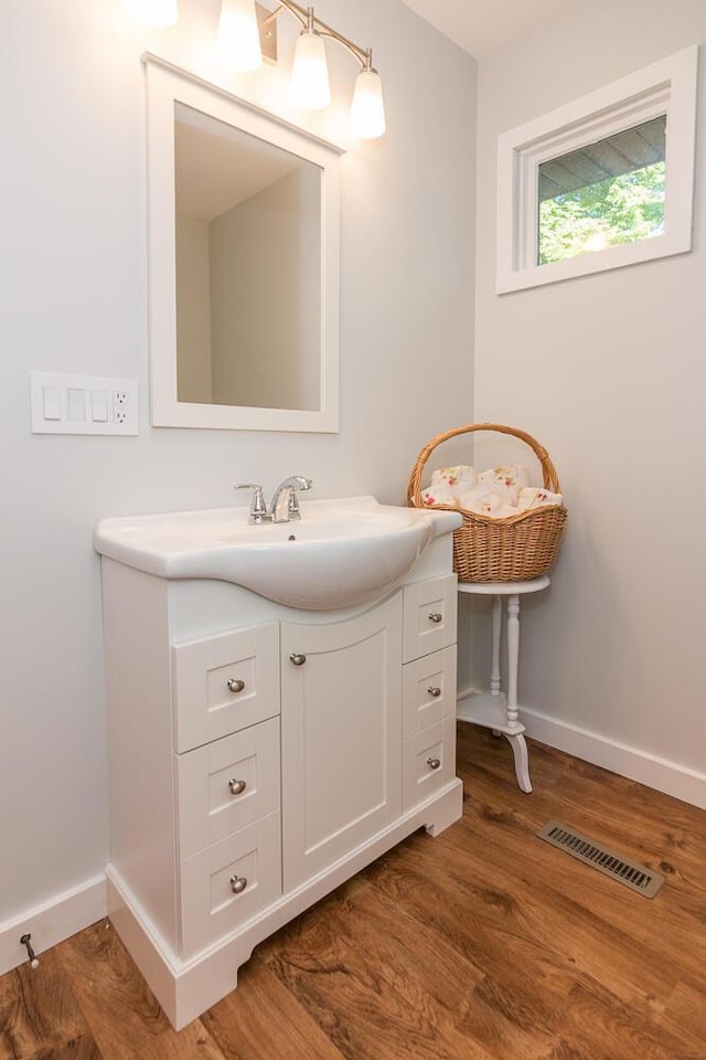 bathroom with hardwood / wood-style flooring and vanity