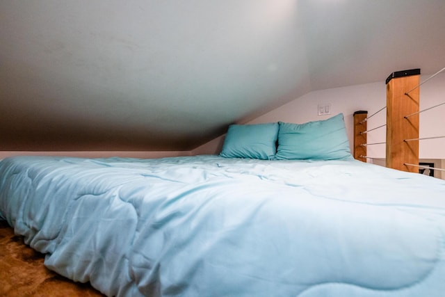 bedroom with lofted ceiling and carpet floors