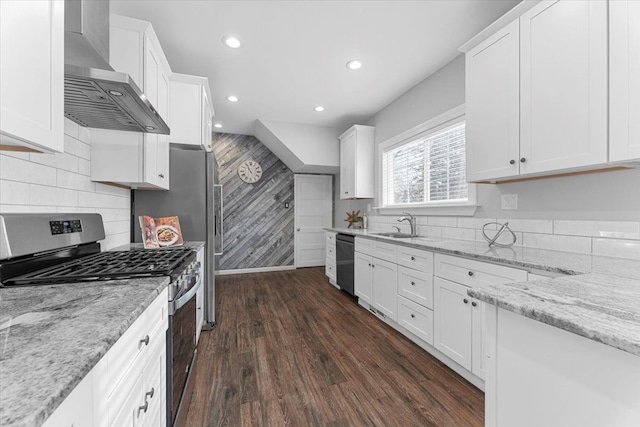 kitchen with white cabinets, stainless steel appliances, and wall chimney exhaust hood