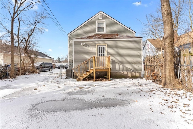 view of snow covered rear of property