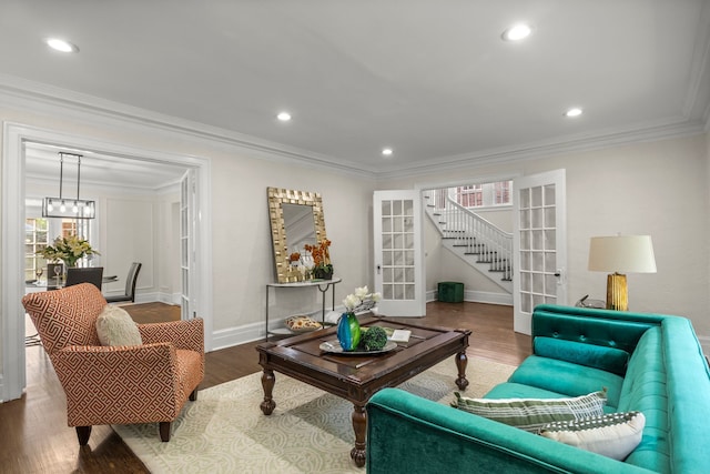 living room with french doors, wood-type flooring, and ornamental molding