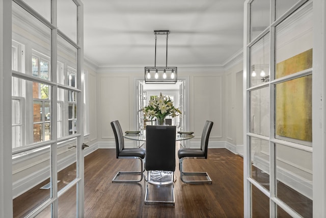 dining area featuring crown molding and dark wood-type flooring