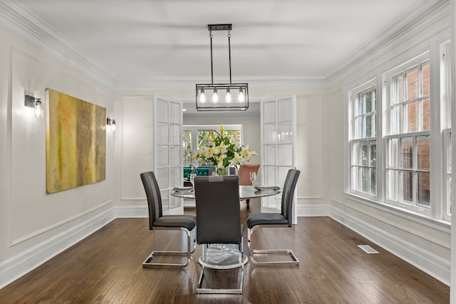 dining room featuring a healthy amount of sunlight, crown molding, and french doors