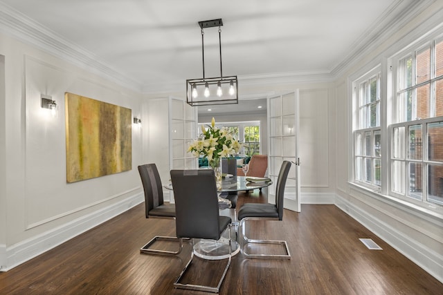 dining area with dark hardwood / wood-style flooring, french doors, and ornamental molding