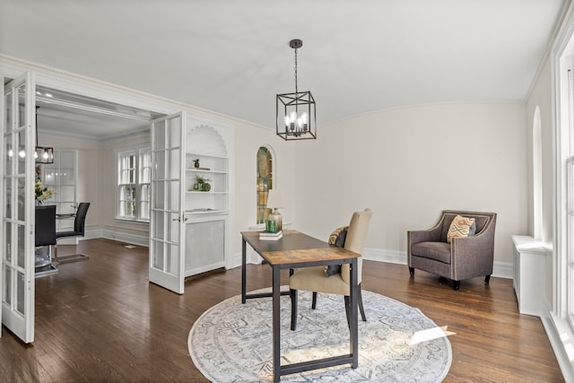 home office featuring built in shelves, french doors, dark wood-type flooring, a notable chandelier, and lofted ceiling