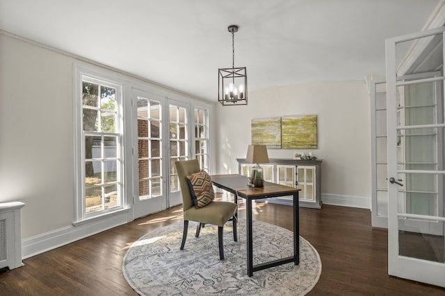 dining area with dark hardwood / wood-style flooring, french doors, and a notable chandelier