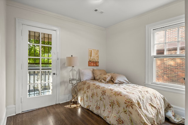 bedroom featuring access to exterior, dark hardwood / wood-style floors, and ornamental molding