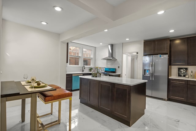 kitchen with dark brown cabinets, a center island, stainless steel appliances, and wall chimney exhaust hood