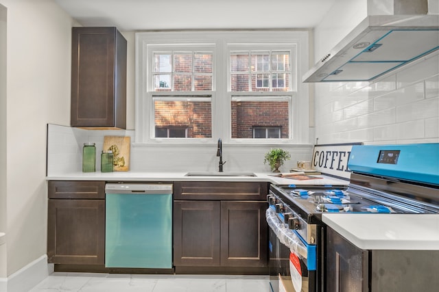 kitchen with sink, stainless steel appliances, wall chimney range hood, tasteful backsplash, and dark brown cabinets