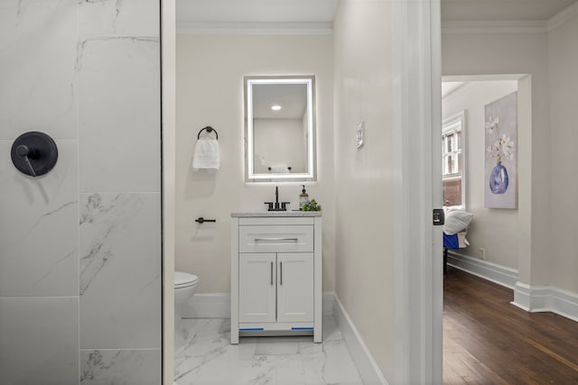 bathroom with vanity, toilet, and ornamental molding