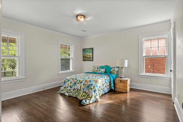 bedroom with dark hardwood / wood-style flooring, multiple windows, and ornamental molding