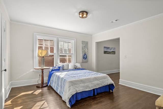 bedroom with dark hardwood / wood-style flooring and crown molding