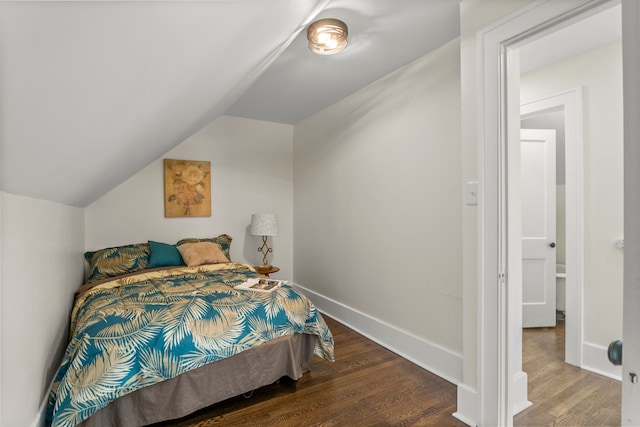 bedroom with lofted ceiling and wood-type flooring