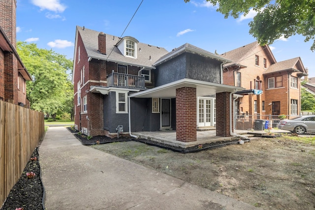 back of property with a balcony