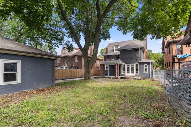 rear view of property featuring a yard