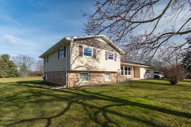 rear view of house featuring a lawn