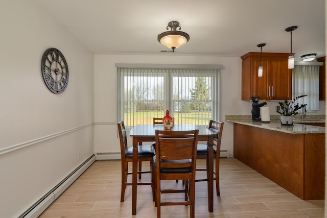 dining space featuring a baseboard heating unit