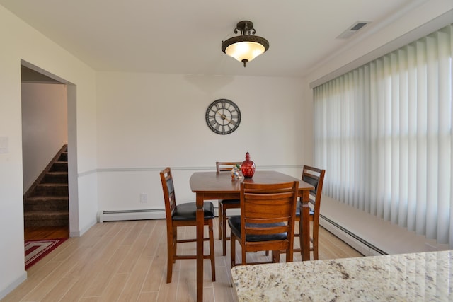 dining room featuring light hardwood / wood-style flooring and a baseboard radiator