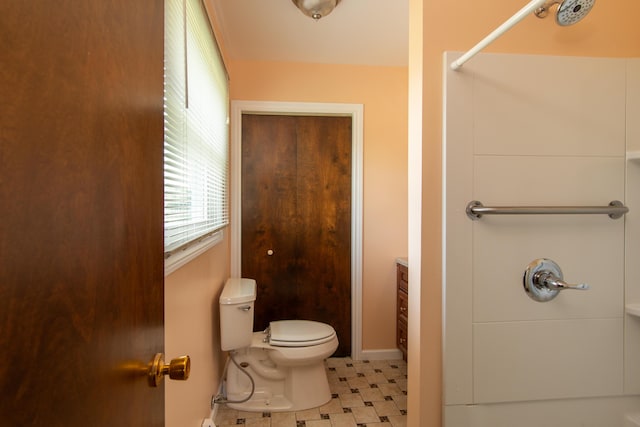 bathroom featuring toilet and a shower