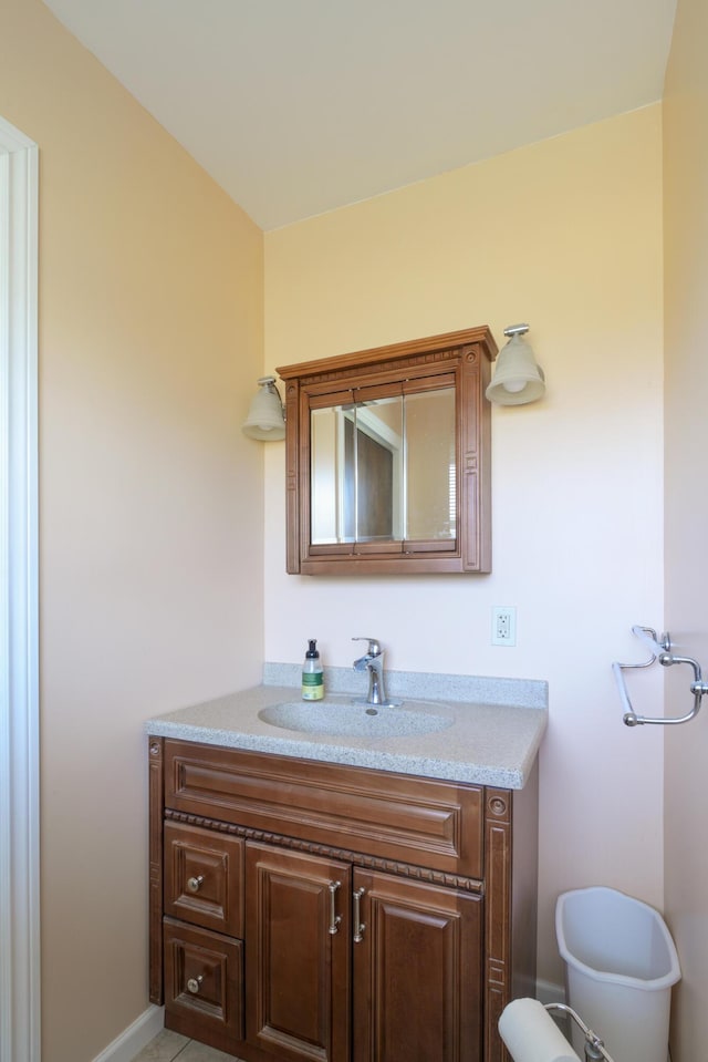 bathroom featuring tile patterned flooring and vanity