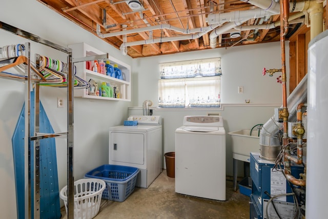 clothes washing area with sink and independent washer and dryer