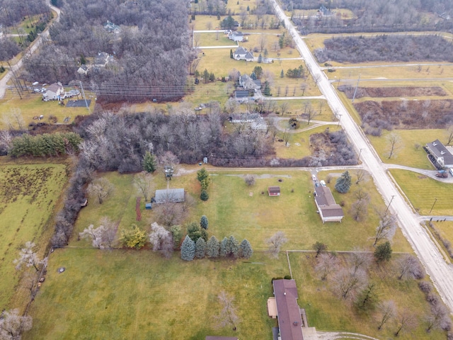 birds eye view of property with a rural view