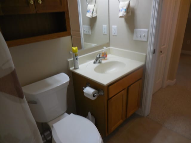 bathroom featuring toilet and vanity