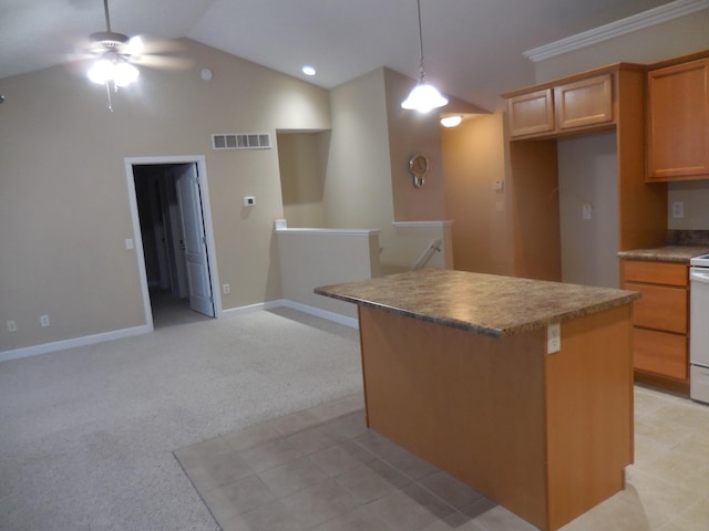 kitchen featuring light carpet, a kitchen island, visible vents, a ceiling fan, and vaulted ceiling