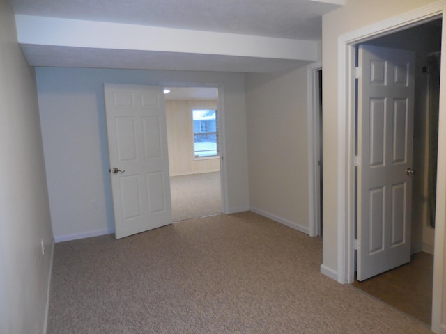 spare room with carpet and baseboards