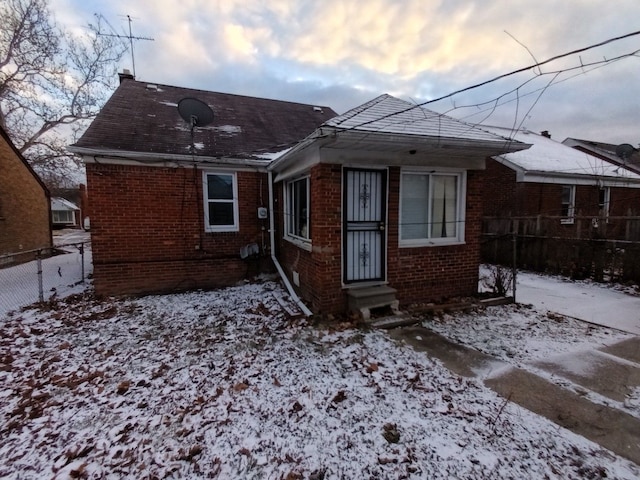 view of snow covered rear of property