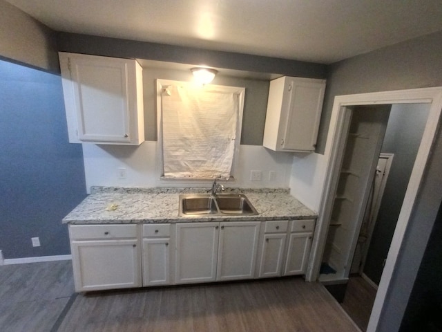 kitchen with white cabinetry, sink, and dark wood-type flooring