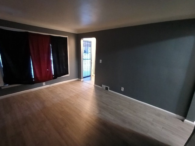 spare room with hardwood / wood-style flooring