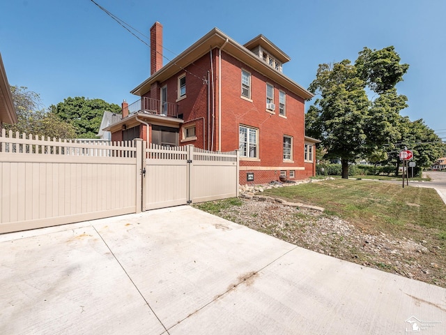 view of side of home with a balcony