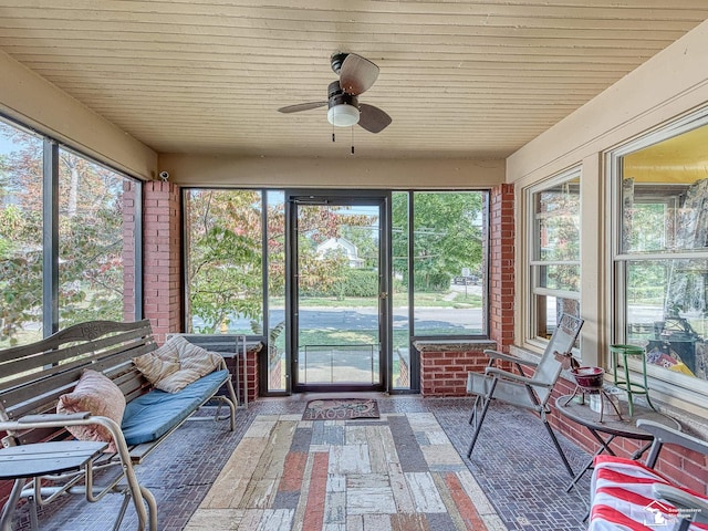 unfurnished sunroom featuring ceiling fan and wooden ceiling