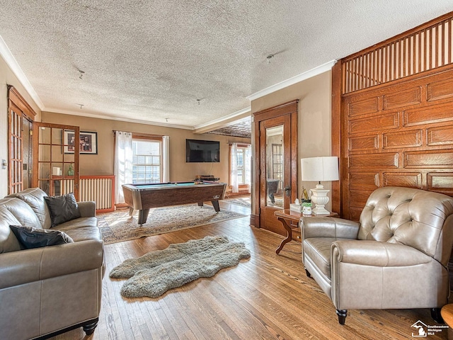 playroom with a textured ceiling, light hardwood / wood-style floors, crown molding, and pool table