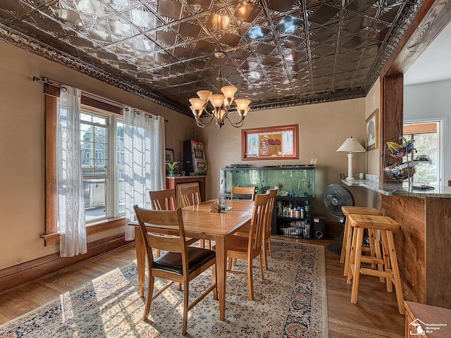 dining room with a chandelier and wood-type flooring